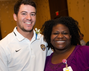 Former LSU placekicker Colby Delahoussaye honors everyday hero BRG Regional Burn Center Medical Director Dr. Tracee Short at BRG’s Experience the Difference Luncheon. 
